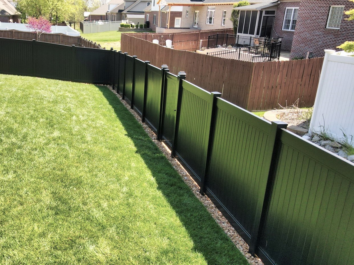 Photo of a black vinyl fence surrounding a back yard